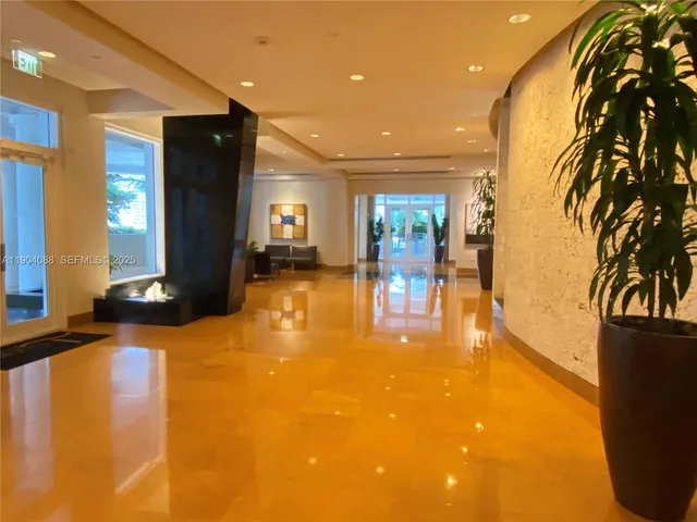 a view of a lobby with black carpet
