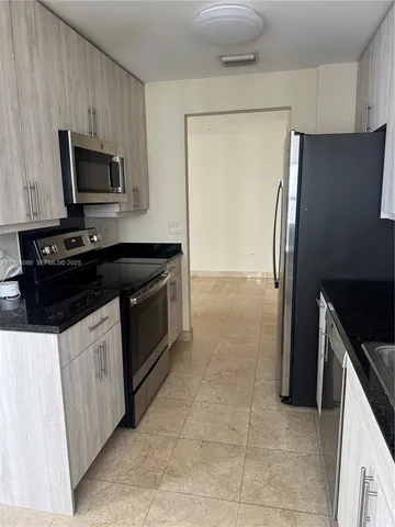 a kitchen with a refrigerator stove and microwave