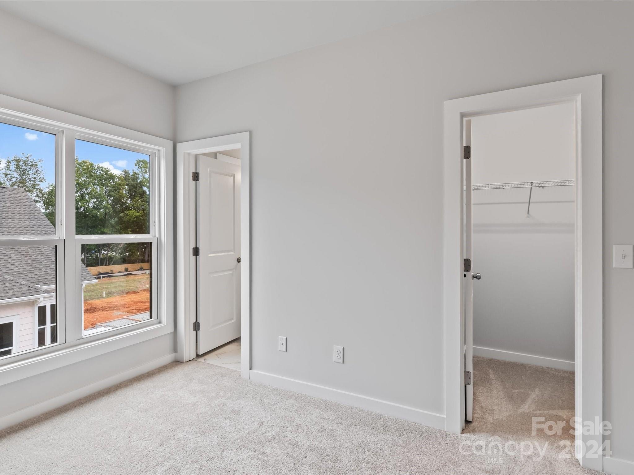 230 Gilead Road Huntersville, NC 28078 - Photo 14 of 19 an empty room with windows and closet