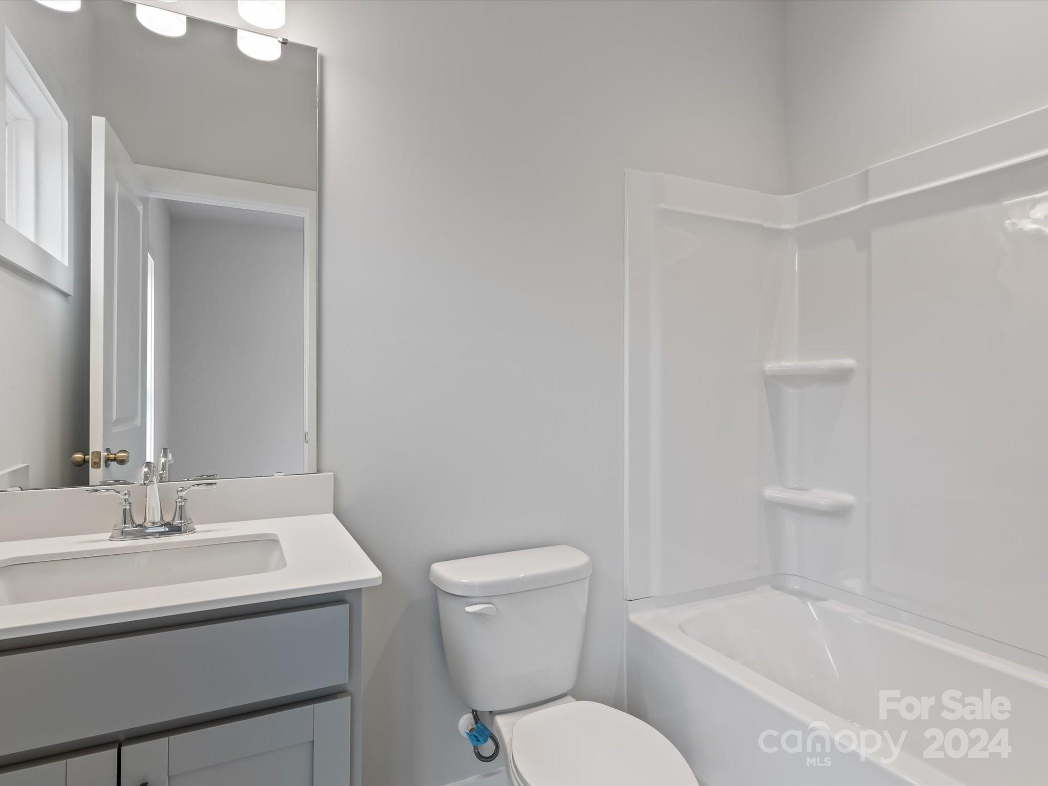 230 Gilead Road Huntersville, NC 28078 - Photo 15 of 19 a bathroom with a sink toilet vanity and bathtub