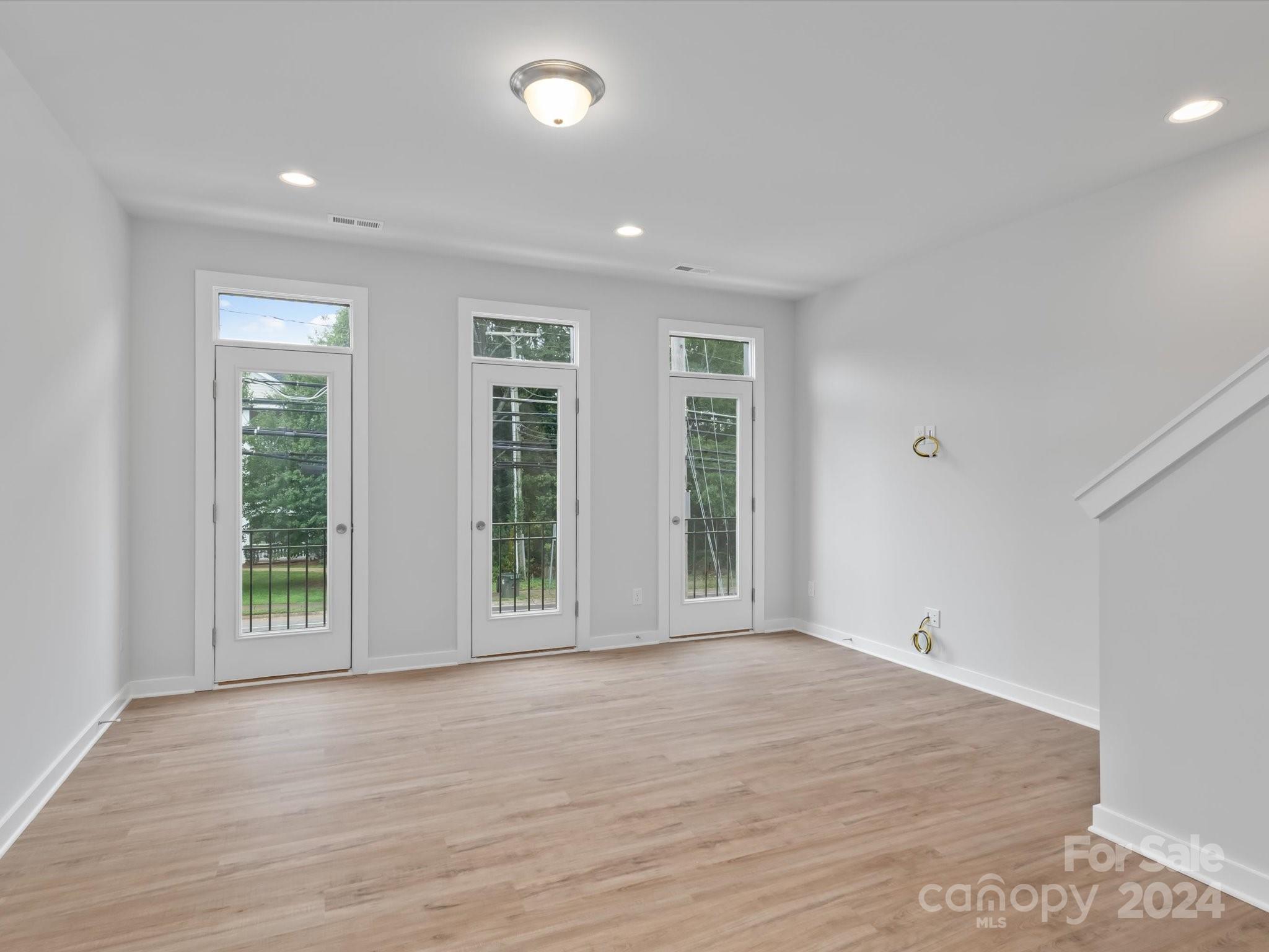 230 Gilead Road Huntersville, NC 28078 - Photo 9 of 19 wooden floor in an empty room with a window