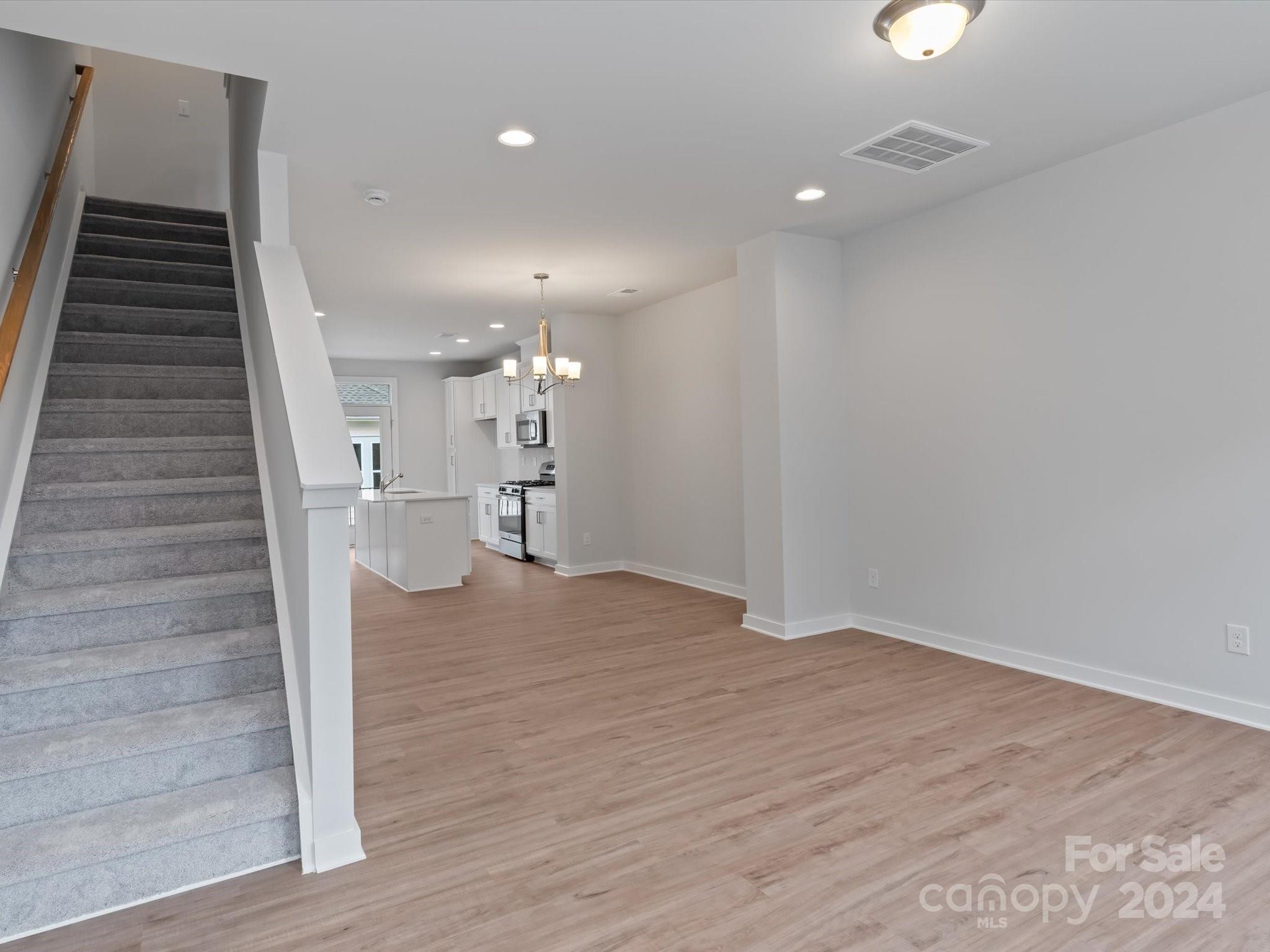 230 Gilead Road Huntersville, NC 28078 - Photo 10 of 19 wooden floor in an empty room with a window
