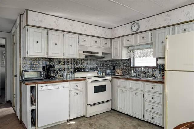 a kitchen with stainless steel appliances a stove a refrigerator and cabinets