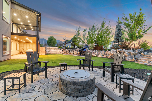 1526 South 500 West Mapleton, UT 84664 - Photo 25 of 54 Patio terrace at dusk with a patio, a fire pit, a balcony, a fenced backyard, and a mountain view