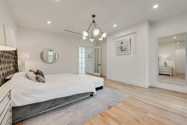 a bedroom with a bed and a chandelier