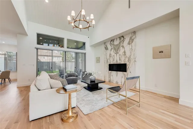 a living room with furniture fireplace and wooden floor