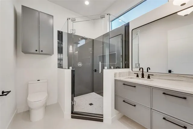 a bathroom with a shower sink and toilet