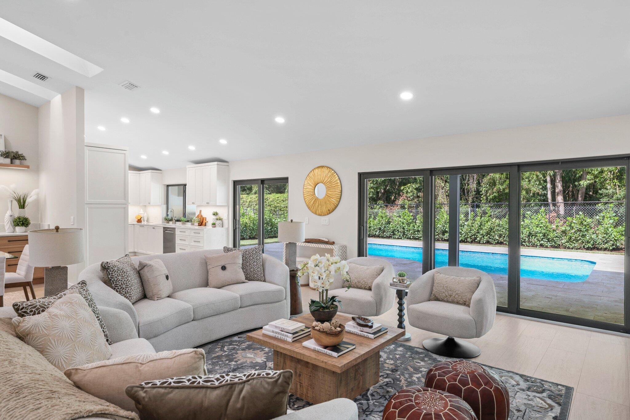 3901 Northwest 27th Avenue Boca Raton, FL 33434 - Photo 12 of 56 a living room with furniture and a large window