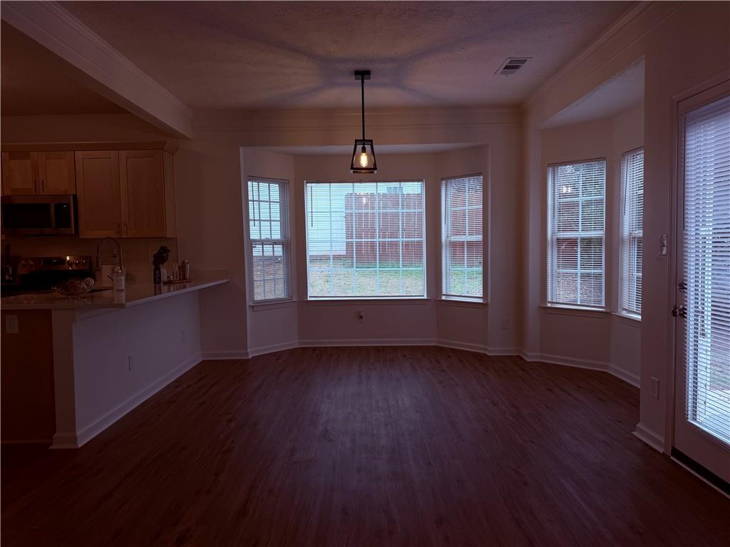 28 Hampton Drive Cartersville, GA 30121 - Photo 7 of 24 a view of an empty room with wooden floor and a window