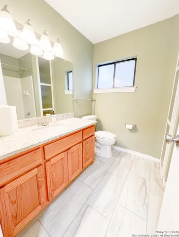 a spacious bathroom with a double vanity sink mirror and toilet