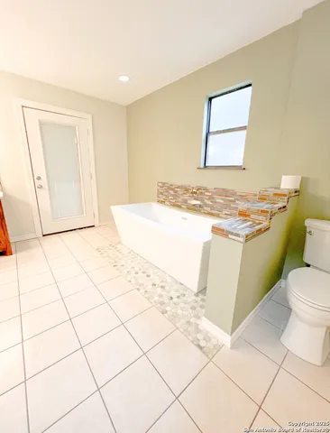 a bathroom with a sink toilet and mirror