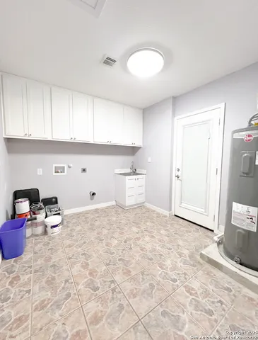 a view of a kitchen with a sink and a cabinet in it