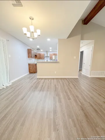 a view of a kitchen with marble the kitchen counter top and wooden floor