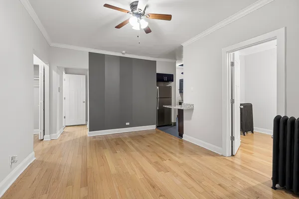 a view of empty room with wooden floor