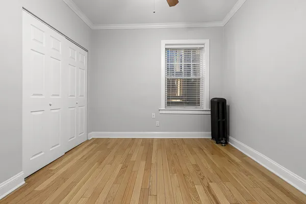 a view of a room with wooden floor and a window