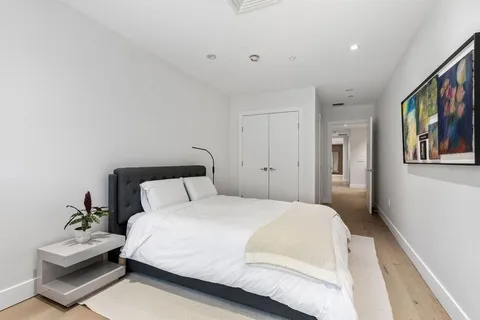 a bedroom with a bed and a large mirror