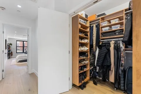 a view of walk in closet with clothes and shoes