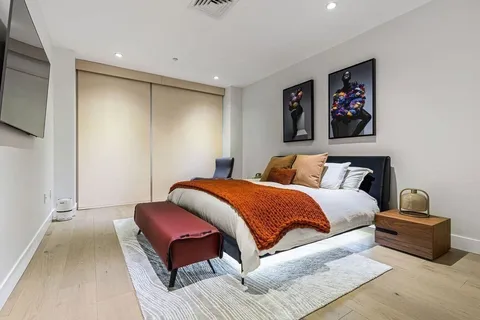 a bedroom with bed and wooden floor