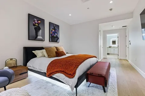 a bedroom with a bed and a couch