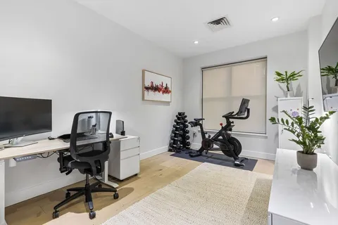 a view of a workspace with furniture and a potted plant