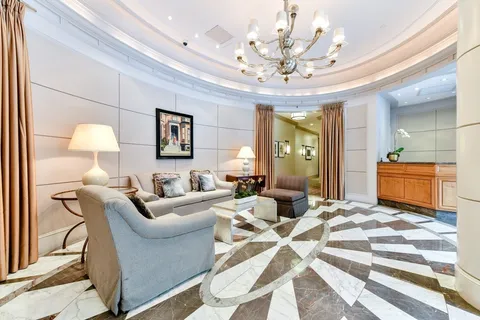 a living room with furniture and a chandelier
