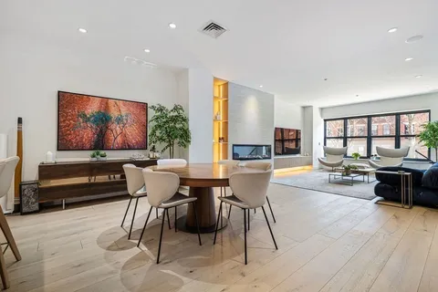 a living room with furniture a rug and a flat screen tv