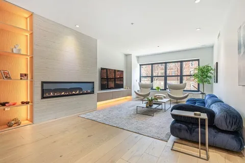 a living room with furniture and a floor to ceiling window