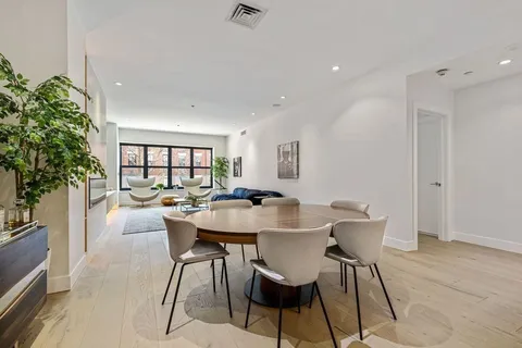 a view of a dining room with furniture and window
