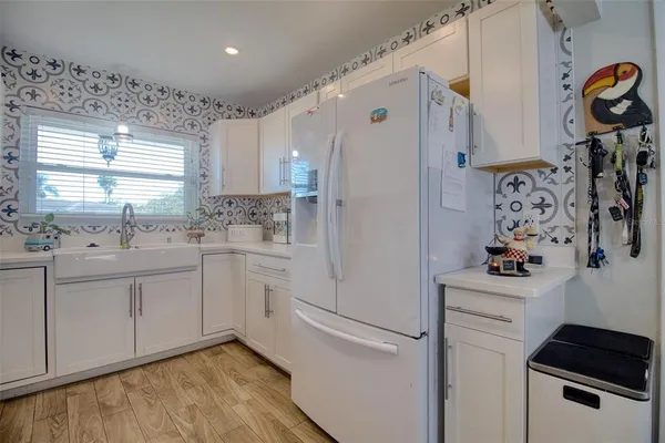a kitchen with a refrigerator and a sink