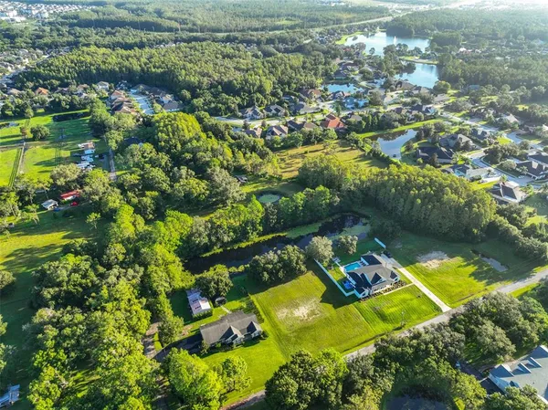 an aerial view of a house with a yard