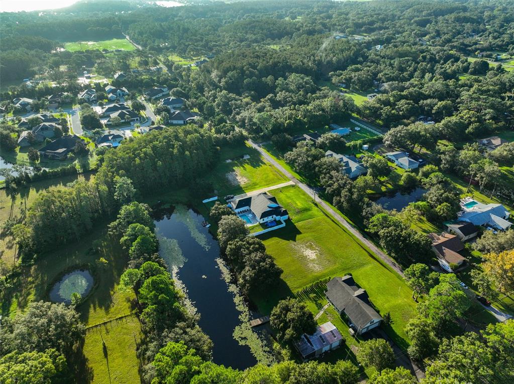 0 Phillips Road, Unit 2 Odessa, FL 33556 - Photo 16 of 22 an aerial view of residential houses with outdoor space and trees