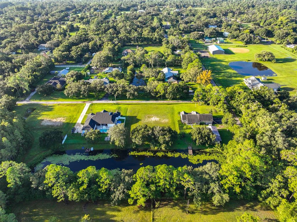 0 Phillips Road, Unit 2 Odessa, FL 33556 - Photo 18 of 22 an aerial view of a residential houses with swimming pool and outdoor space