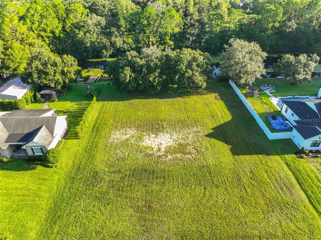 0 Phillips Road, Unit 2 Odessa, FL 33556 - Photo 2 of 22 a view of a swimming pool with an outdoor space and seating area