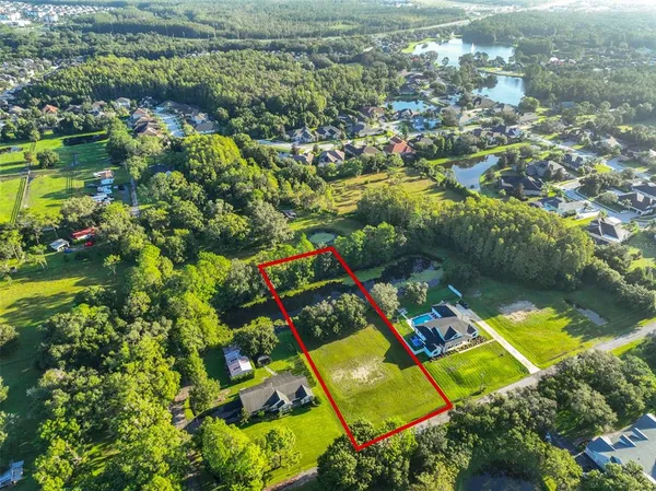 an aerial view of a houses with a yard