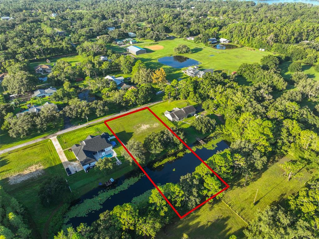 0 Phillips Road, Unit 2 Odessa, FL 33556 - Photo 5 of 22 an aerial view of a residential houses with a yard and lake view