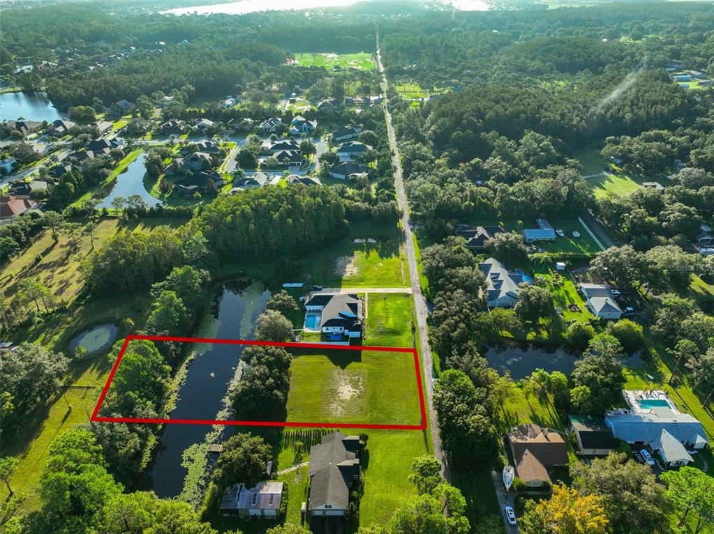 0 Phillips Road, Unit 2 Odessa, FL 33556 - Photo 9 of 22 an aerial view of a house with a yard and lake view