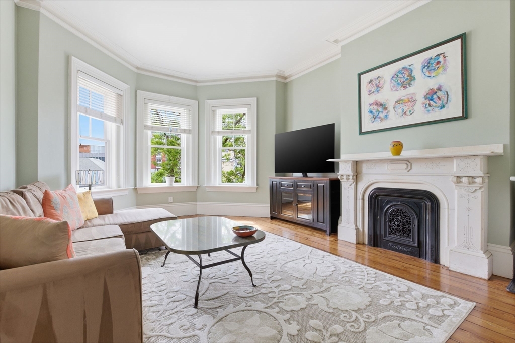 419 Main Street Boston, MA 02129 - Photo 13 of 41 a living room with furniture a flat screen tv and a fireplace