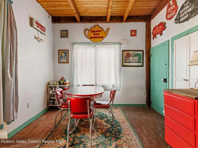 a view of a patio with couches table and chairs with potted plants and a fireplace