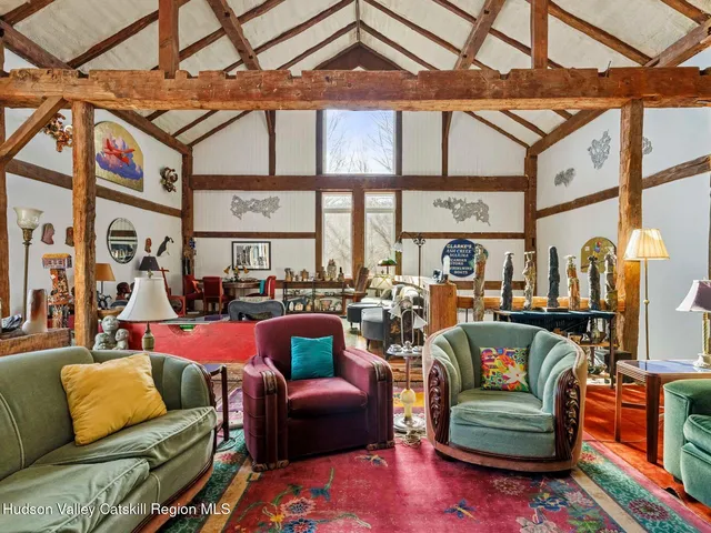 a view of a patio with table and chairs under an umbrella