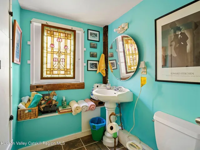 a bathroom with a toilet a sink and a shower curtain
