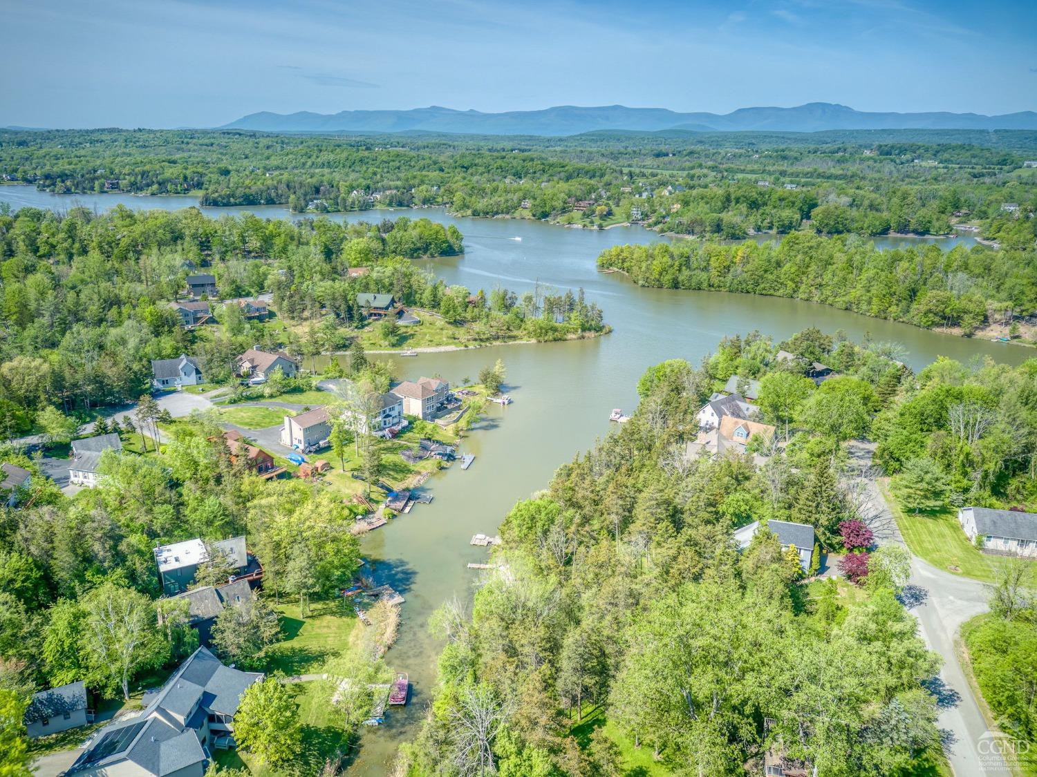90 Sleepy Hollow Road Athens, NY 12015 - Photo 3 of 6 an aerial view of green landscape with trees houses and lake view
