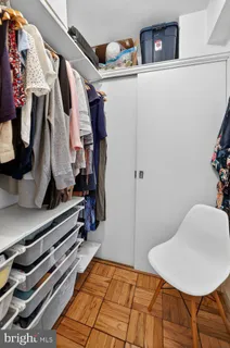 a view of walk in closet with clothes and shoes