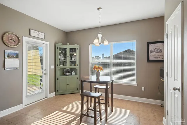 a dining room with furniture and window
