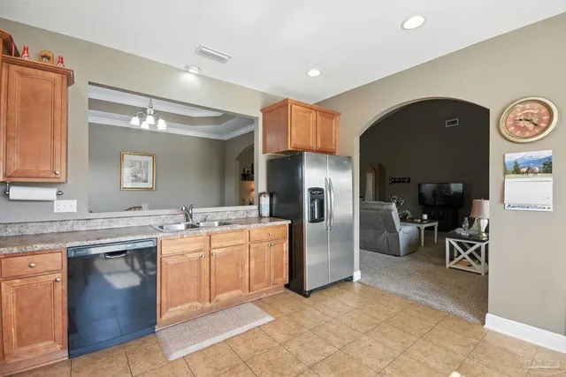a kitchen with stainless steel appliances granite countertop a sink and cabinets