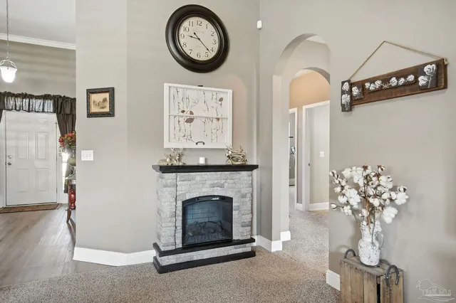 a living room with furniture a clock and a fireplace