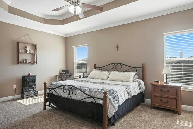 a bedroom with a bed and a chandelier