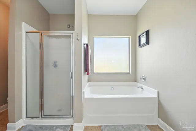 a white bath tub sitting next to a shower