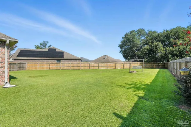 a view of a house with a backyard