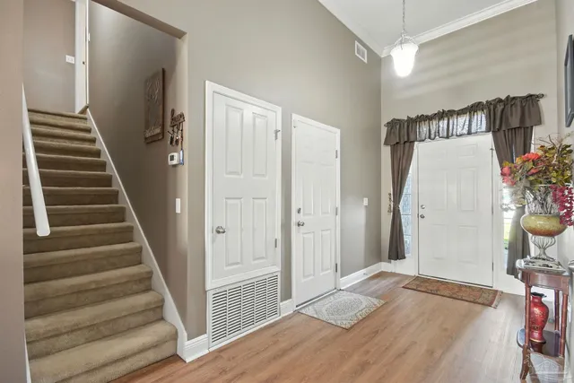 a view of entryway and hall with wooden floor