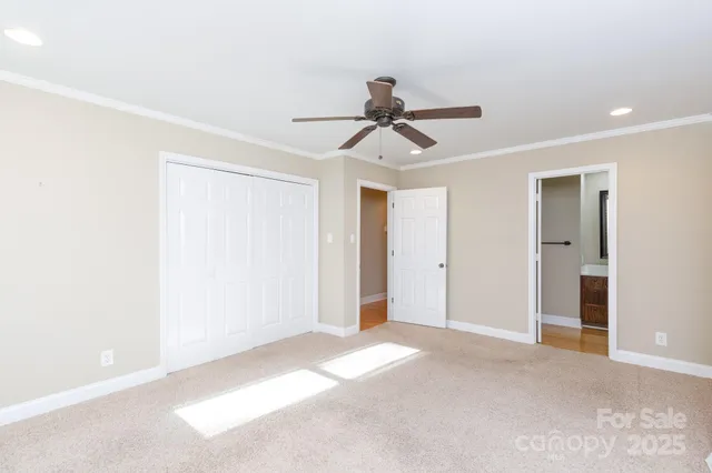 a view of a big room with chandelier fan and windows